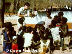 Delia Owens with children in village